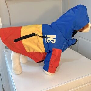 Dog vests, shirts, coats and raincoats of various sizes and colors.